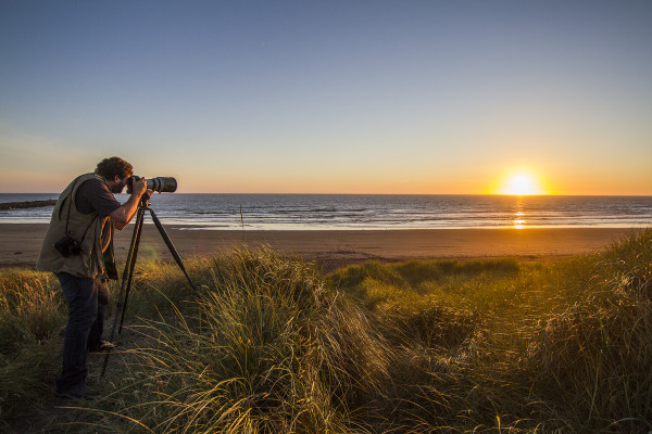 Kyle Mittan | The Daily World Ocean Shores-based photographer Stuart May shoots photographs of the sunset off the coast in mid-June. May, who shot April's lunar eclipse, says a sturdy tripod is key to successfully photographing the moon.