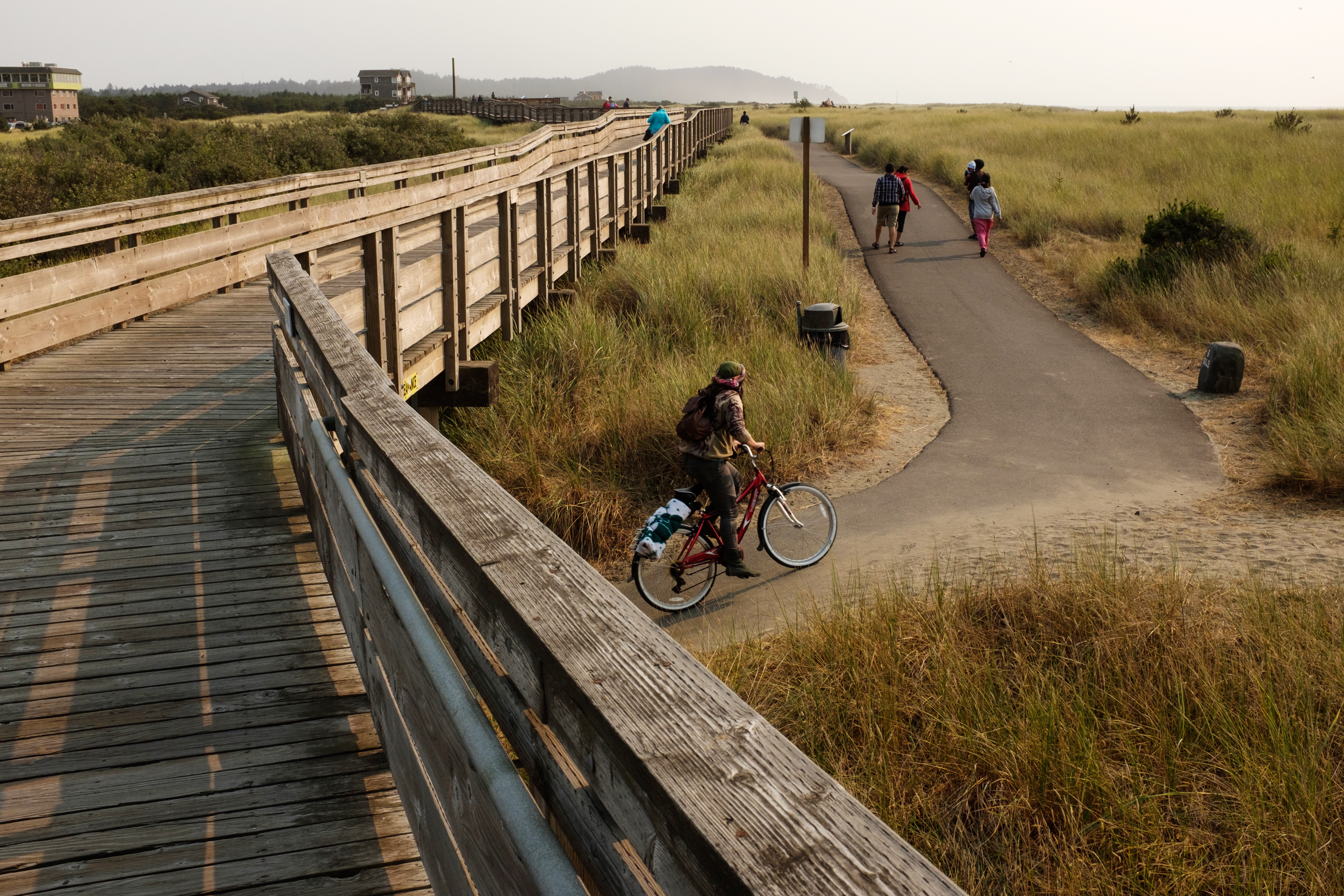 DAMIAN MULINIX A bicyclist on the Discovery Trail passes under the Long Beach Boardwalk.