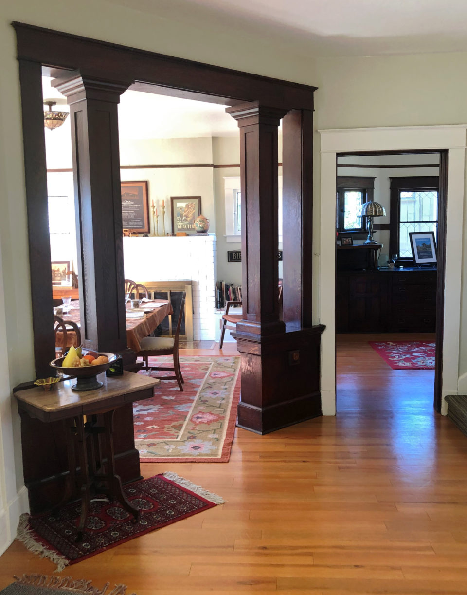 This is the view to the left upon entering the front doors. Through the columns is a dining room with bay windows.