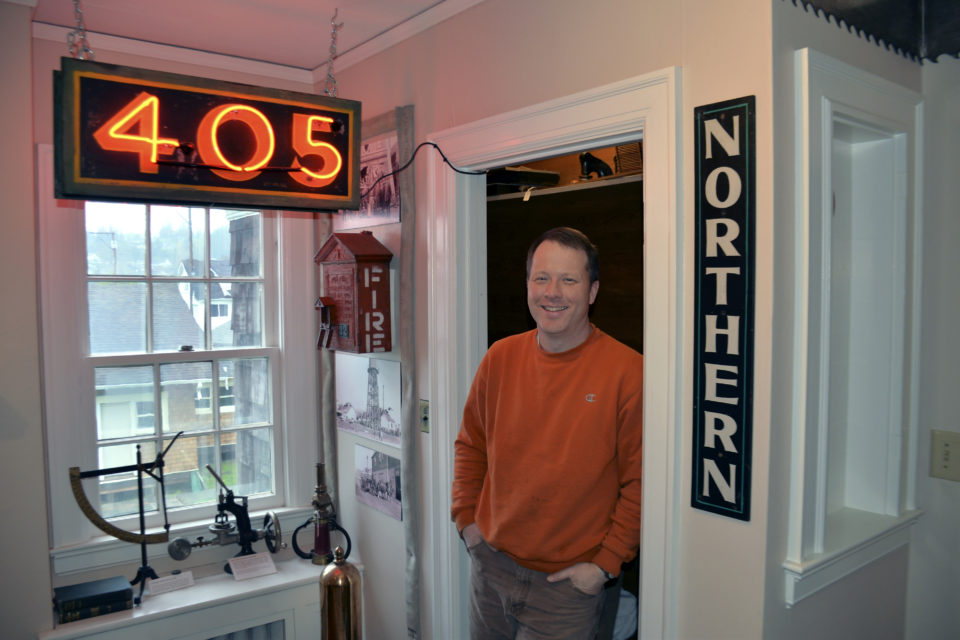 Photo by Dan Hammock John Larson, director of the Polson Museum in Hoquiam, stands between the original neon sign from the 405 brothel and a simple wooden sign for the Northern, another of Aberdeen’s “sporting houses” from the 1950s. The 405 was a small, white two-story building that usually had two working girls at a time. The sign was donated by a local resident who salvaged it as the building was being demolished.